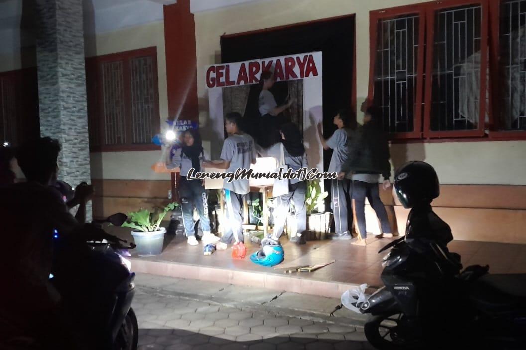 Foto pembuatan foto booth di saat listrik padam dengan bantuan lampu sepeda motor dan hp oleh Pengurus OSIS