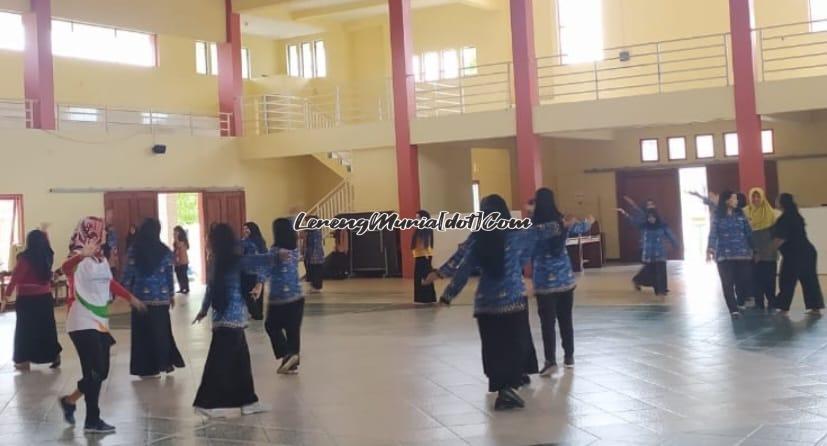 Foto guru/karyawan sedang mengikuti latihan tari kompilasi di auditorium