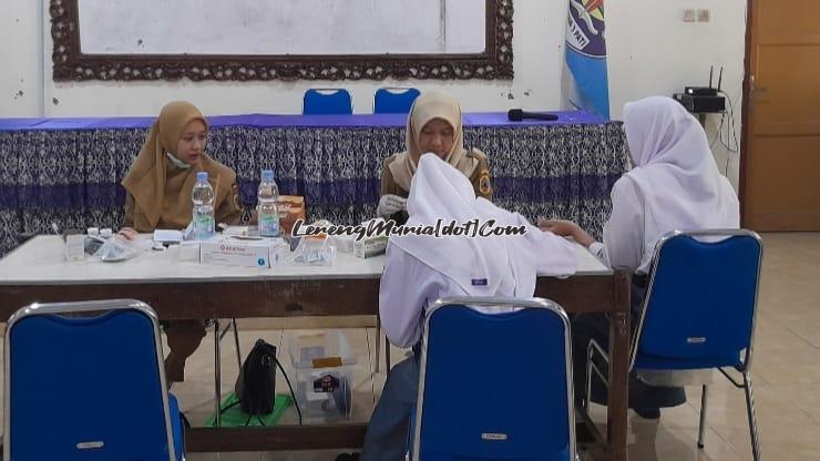 Foto dua petugas dari Puskesmas Pati I Ayudya Safitri, A.Md.Kes. (kiri) dan Umi Yuli Purwanti, S.Gz. (kanan) memeriksa Hb dan edukasi anemia kepada siswa kelas X SMAN 3 Pati